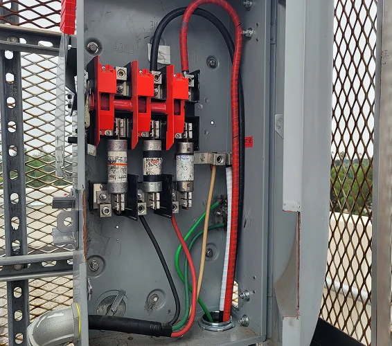LCE Telecom electrical equipment panel with circuit protection devices and connected power cables.